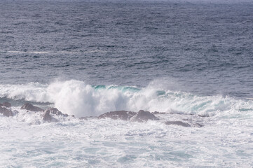 Spectacularly big waves from the pacific ocean smash into the californian coast along US highway 1.
