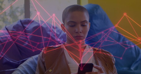 Image of network of connections over biracial woman using smartphone