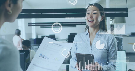 Image of financial data processing over diverse colleagues discussing work in office