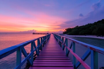 A brightly colored wooden boardwalk stretches over a calm beach