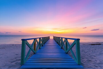 Obraz premium A brightly colored wooden boardwalk stretches over a calm beach