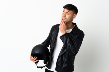 Man with a motorcycle helmet isolated on white background looking up while smiling