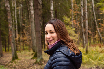 Beautiful woman walking in autumn park outdoor