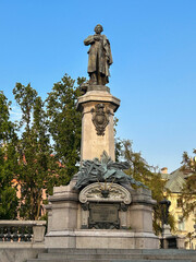 Obraz premium Beautiful view of monument of Adam Mickiewicz in the summer garden.Warsaw. Poland.