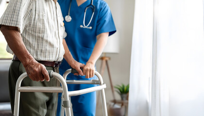 Doctor or nurse caregiver with senior man using walker assistance at nursing home