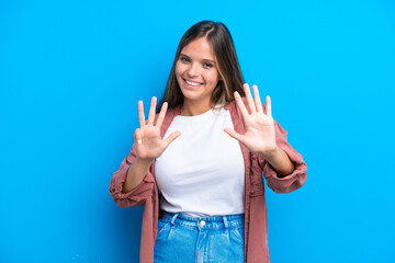 Young caucasian woman isolated on blue background counting nine with fingers