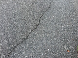 Broken asphalt road wit on line in the middle