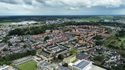 Aerial shot of houses with solar panels on roof in a street in a residential area neighborhood in Steenwijk, Overijssel, The Netherlands.