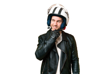 Young handsome blonde man with a motorcycle helmet over isolated chroma key background looking to the side and smiling