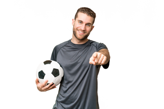 Young handsome blonde man over isolated chroma key background with soccer ball and pointing to the front