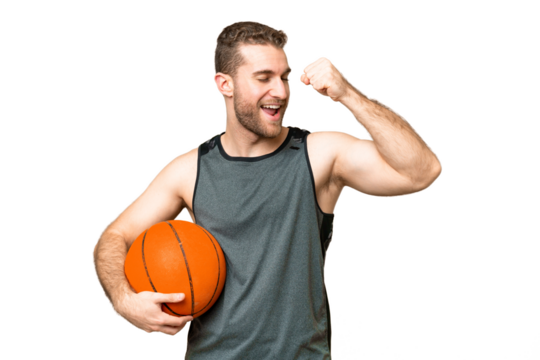 Handsome young man playing basketball over isolated chroma key background celebrating a victory