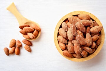 Roasted almonds, sea salt roasted almonds in wooden bowl on white background	