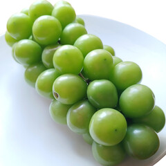 A Bunch of Shine Muscat Green Grapes on a White Plate