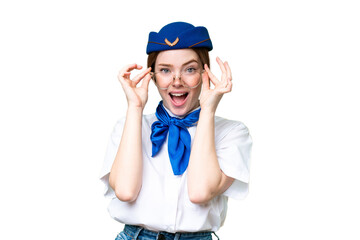 Airplane stewardess over isolated chroma key background with glasses and surprised