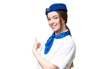 Airplane stewardess over isolated chroma key background pointing back