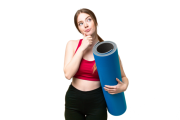 Young sport woman going to yoga classes while holding a mat over isolated chroma key background and looking up