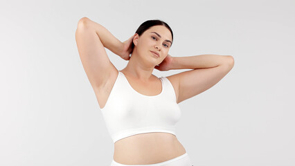 Fototapeta premium A vibrant, confident woman with a full figure poses against a bright backdrop. Perfect for showcasing diversity and promoting body positivity. Ideal for health and lifestyle campaigns.