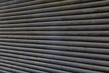 abstract background wall of gray logs