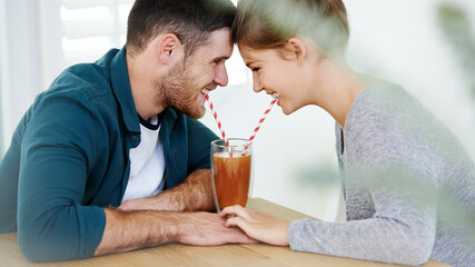 Love, milkshake and holding hands with couple on date for romance, bonding and cafe. Smoothie, coffee shop and care with man and woman sharing drink at restaurant for summer, break and relationship