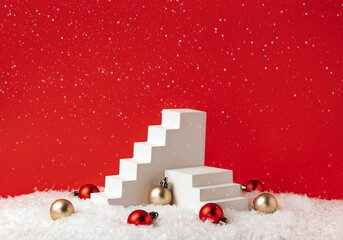 Elegant Christmas Product Presentation Scene made with White Staircase Props Pedestals and Ornaments on the Snow on Red Background. Studio photography.