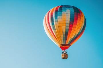 Obraz premium A colorful hot air balloon floating against a clear blue sky