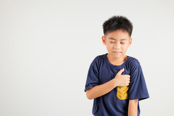 Young kid boy pressing on chest pain isolated on white background, painful expression heartache,...