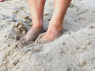 woman's feet on the sand