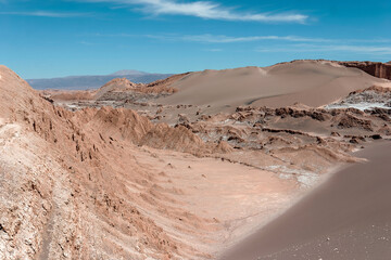 Explore the vibrant colors and unique textures of chile's atacama desert under the bright sun and clear blue sky. A stunning mix of sand dunes. Mountains