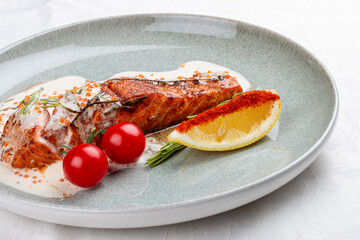 Salmon steak with cream sauce and red caviar