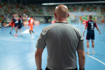 Referee's back during handball match