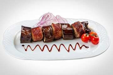 Tender pork kebabs served with roasted eggplant slices.