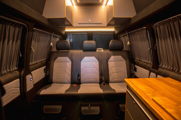 Comfortable interior of a passenger bus with soft seats. The design is made to order. Private...