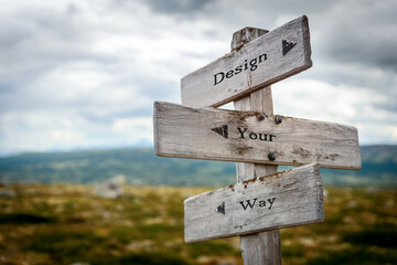 design your way text quote on wooden directional signpost outdoors in nature