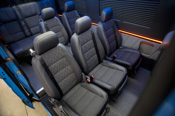 Comfortable interior of a passenger bus with soft seats. The design is made to order. Private covering of cars. Various elements of the bus interior.