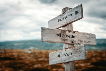 future needs you text quote on wooden directional signpost outdoors in nature