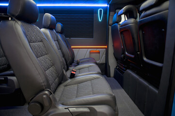 Comfortable interior of a passenger bus with soft seats. The design is made to order. Private...