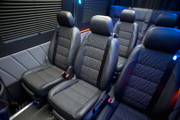 Comfortable interior of a passenger bus with soft seats. The design is made to order. Private covering of cars. Various elements of the bus interior.