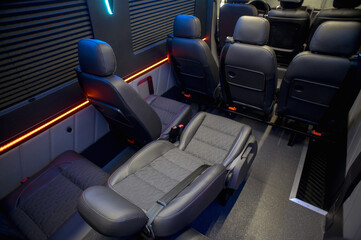 Comfortable interior of a passenger bus with soft seats. The design is made to order. Private...