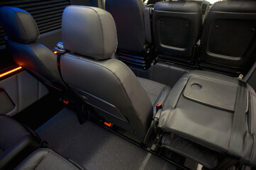 Comfortable interior of a passenger bus with soft seats. The design is made to order. Private covering of cars. Various elements of the bus interior.