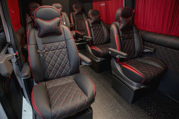 Comfortable interior of a passenger bus with soft seats. The design is made to order. Private...