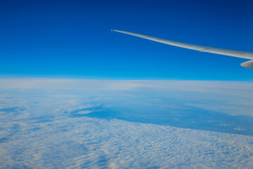 Fototapeta premium China Shanghai - Sunrise above the clouds from the plane