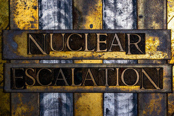Nuclear Escalation text in real authentic typeset letters on vintage textured silver grunge copper and gold background