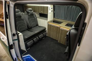 Comfortable interior of a passenger bus with soft seats. The design is made to order. Private...
