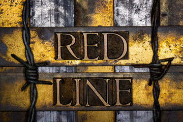 Red Line text with barbed wire in real authentic typeset letters on vintage textured silver grunge copper and gold background