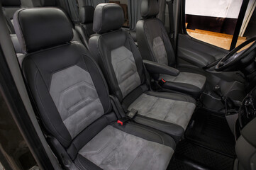 Comfortable interior of a passenger bus with soft seats. The design is made to order. Private...