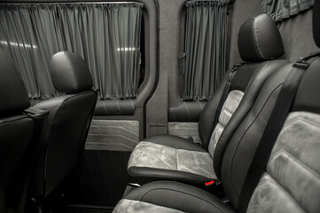 Comfortable interior of a passenger bus with soft seats. The design is made to order. Private...