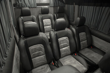 Comfortable interior of a passenger bus with soft seats. The design is made to order. Private covering of cars. Various elements of the bus interior.