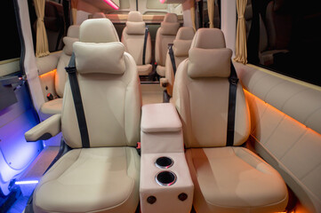 Comfortable interior of a passenger bus with soft seats. The design is made to order. Private...