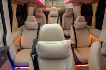 Comfortable interior of a passenger bus with soft seats. The design is made to order. Private...