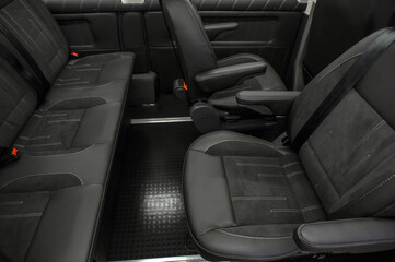 Comfortable interior of a passenger bus with soft seats. The design is made to order. Private...